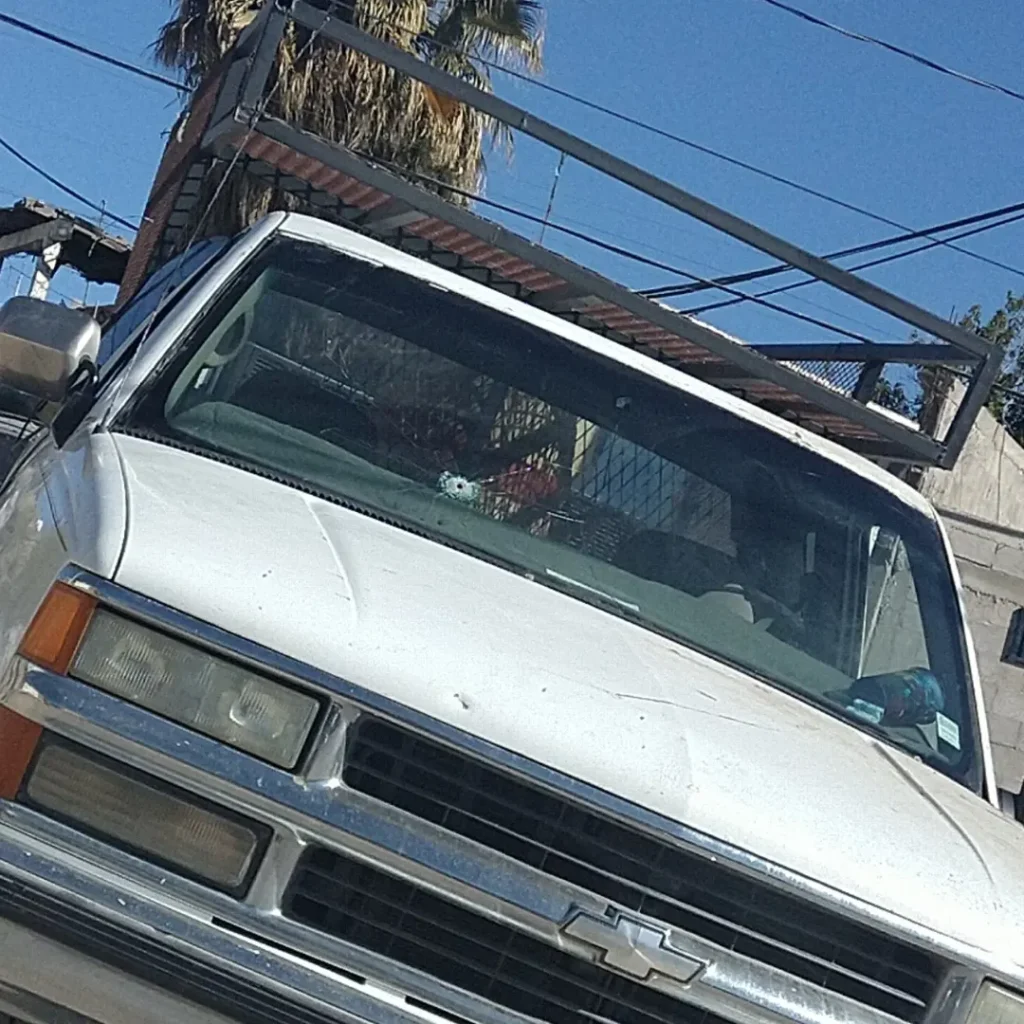 Truck with a bullet hole in the windshield